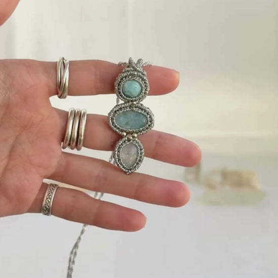 Video of a handmade Larimar, Aquamarine and Moonstone macrame necklace. Displaying natural gemstone colors, light reflections, and fine macrame details.