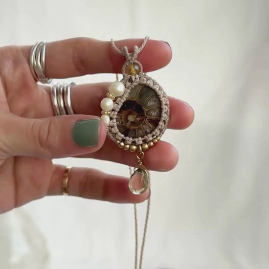 Video showing ammonite fossil necklace details, natural veins, freshwater pearls and luminous lemon quartz drop