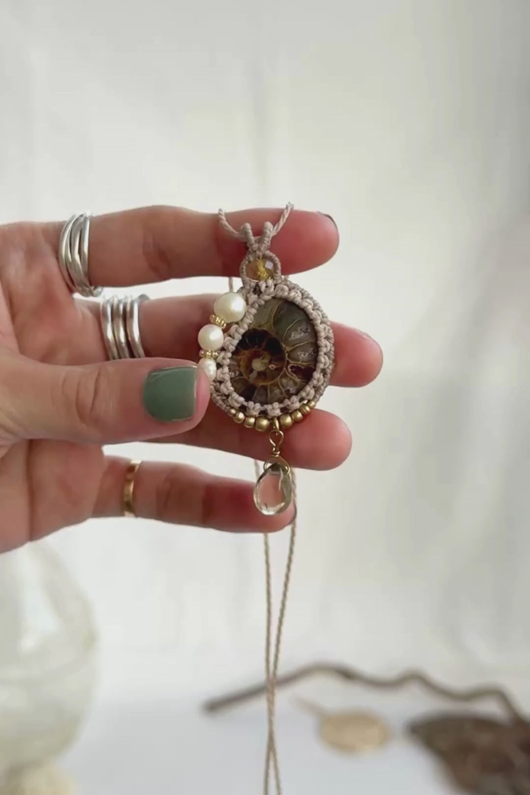Video showing ammonite fossil necklace details, natural veins, freshwater pearls and luminous lemon quartz drop