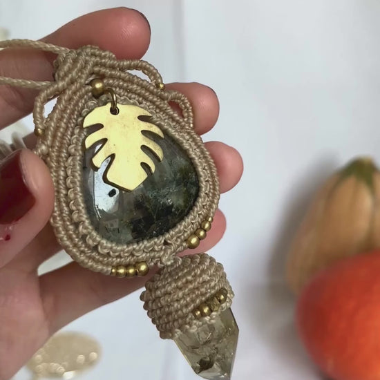 Close-up video of a handmade gemstone necklace, capturing the natural shine and intricate details of Prehnite and Raw Smoky Quartz Point. The unique design and polished gemstones reflect the light beautifully, highlighting the craftsmanship and one-of-a-kind artistry.